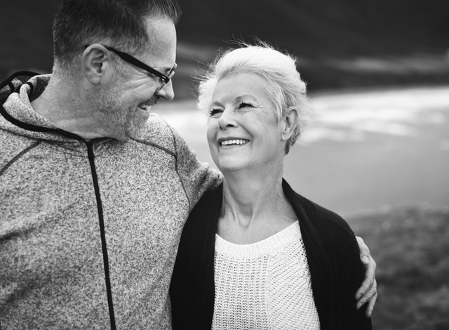 An older couple happily looking at each other 