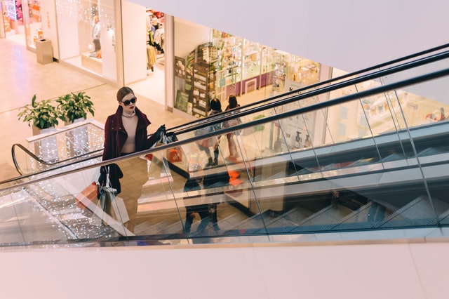 woman holding shopping bags inside a mall