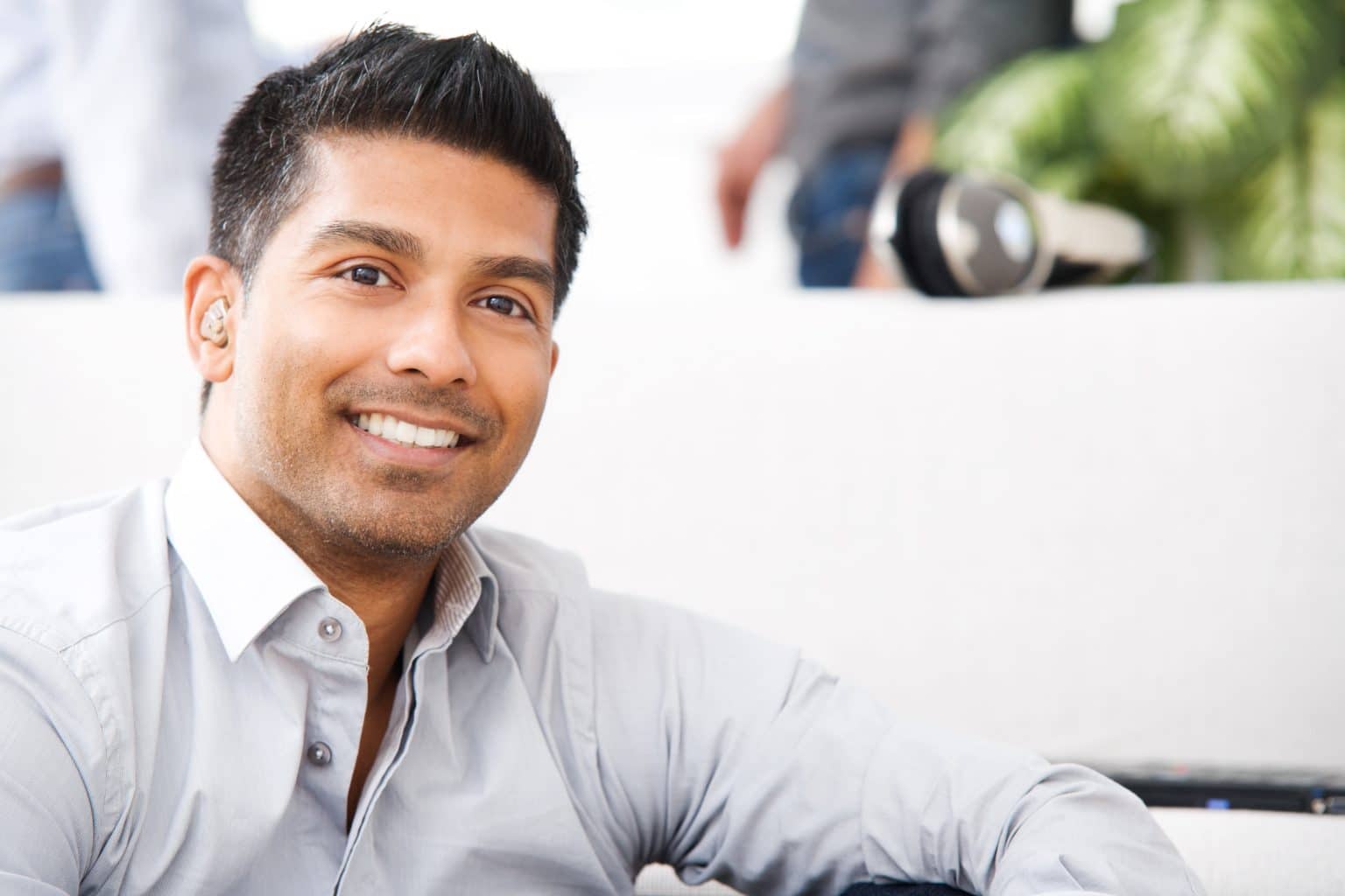 a man with hearing aids relaxes at home