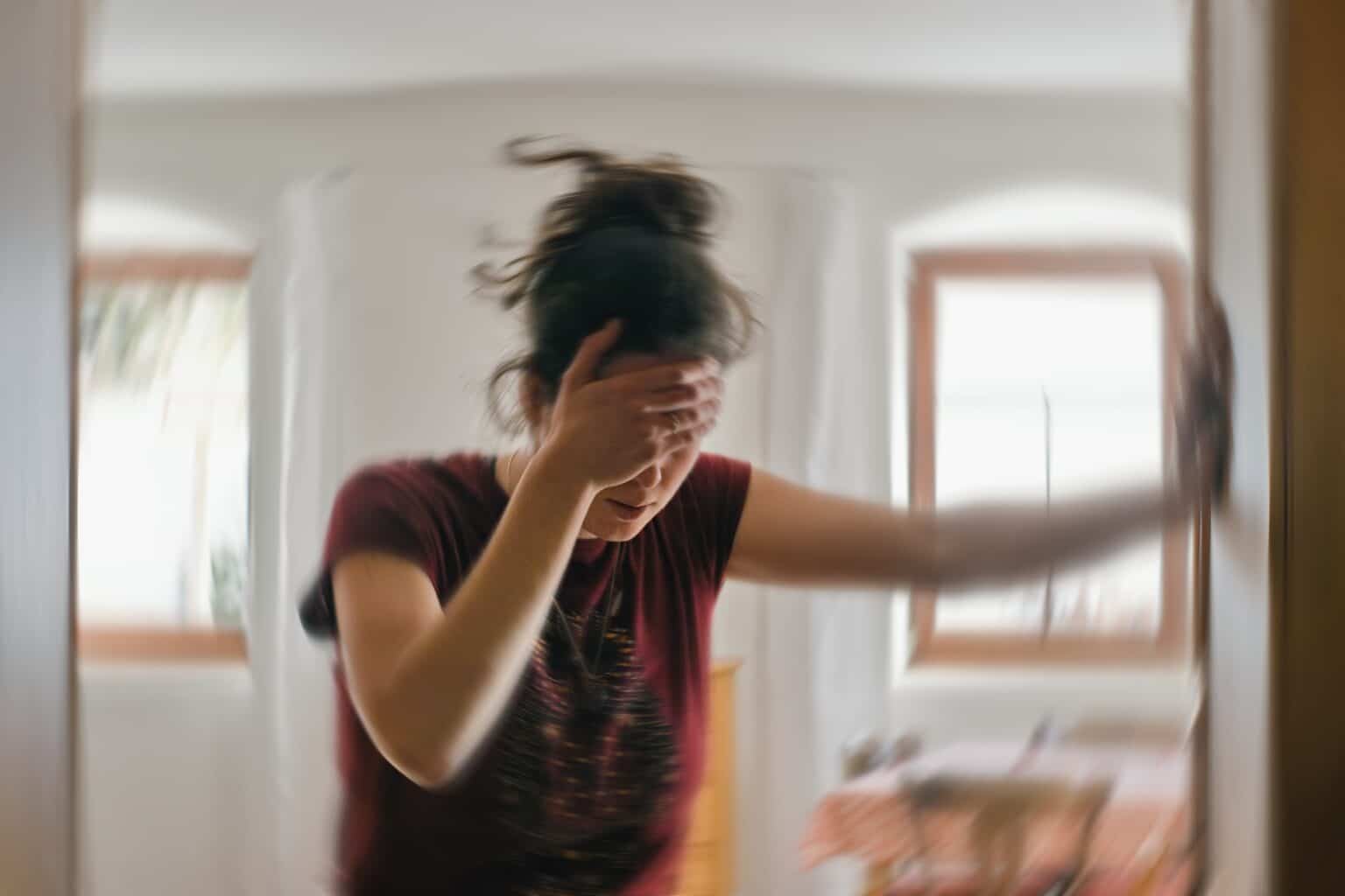 Woman suffering from vertigo or dizziness.