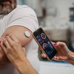 Man checking his blood sugar levels with a smartphone app