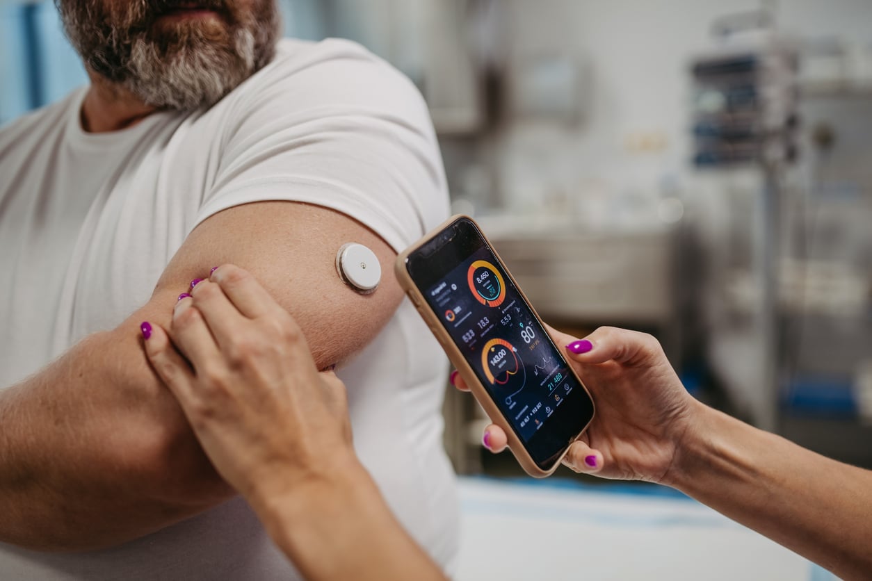 Man checking his blood sugar levels with a smartphone app.