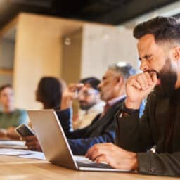 Man yawning in a meeting