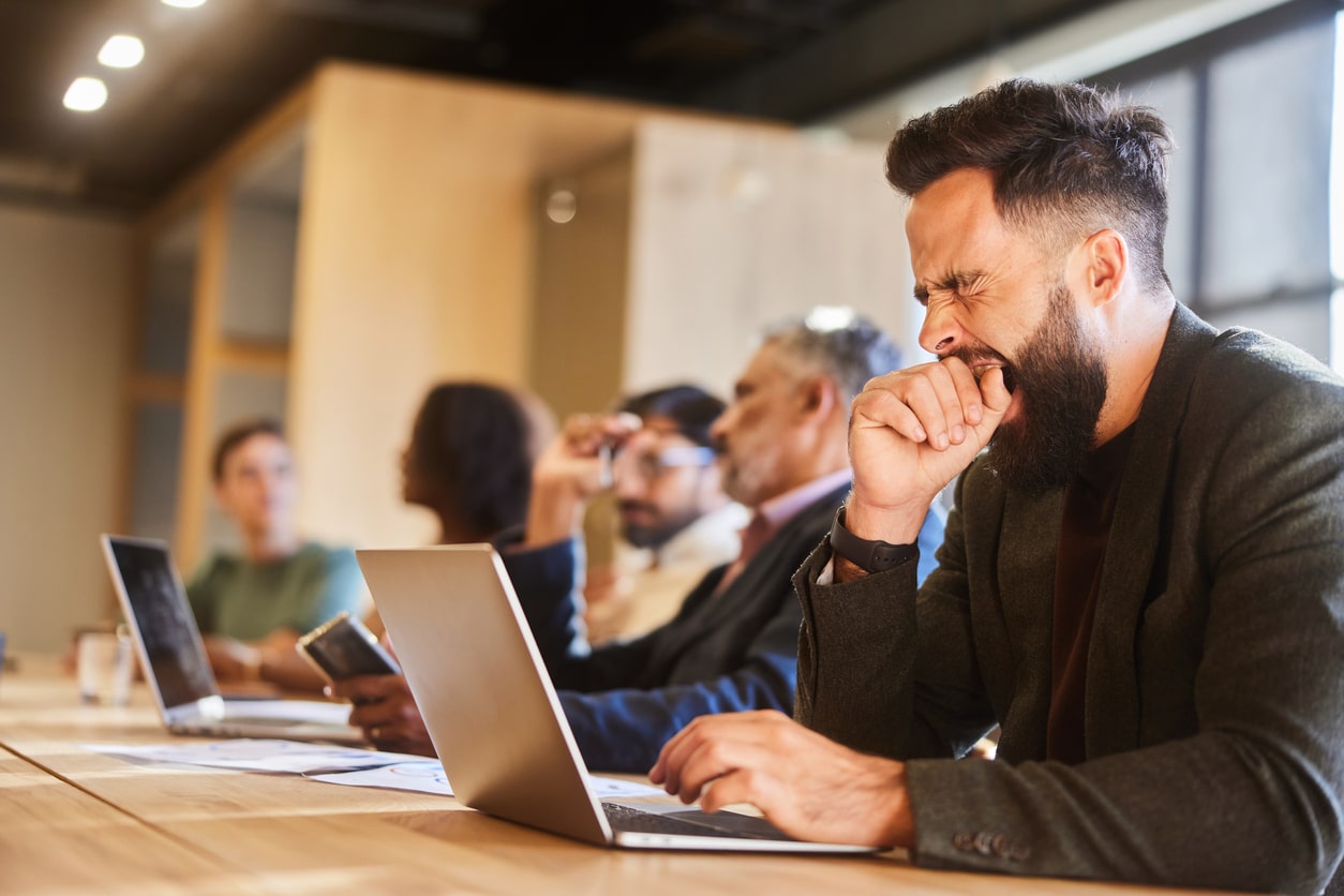 Man yawning in a meeting