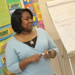 Teacher stands in front of the class