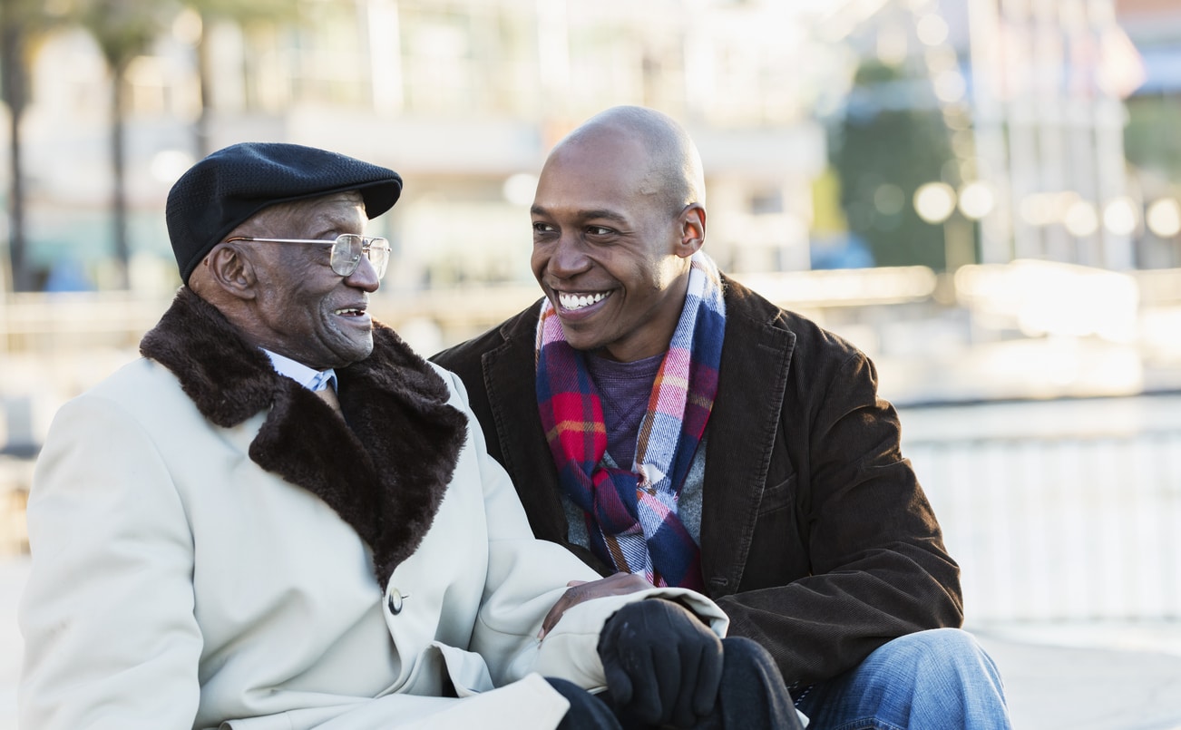 Father and son having a nice conversation in a park on a winter day.