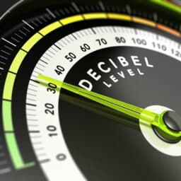 Close up of a dial with "Decibel Level" written on it; monitoring loud volumes